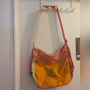 Cotopaxi Taal Crossover Bag with adjustable strap.
